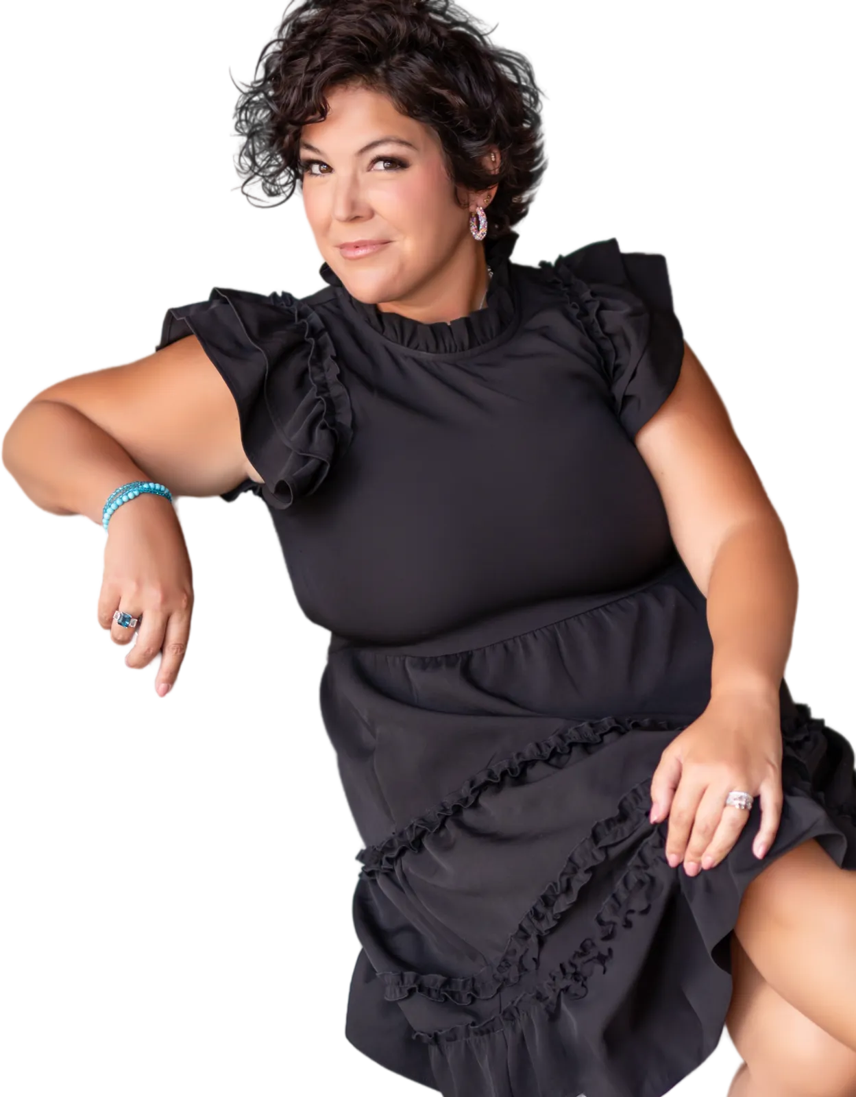 Jessica Doyle-Mekkes seated, looking to camera, in a black ruffled dress.